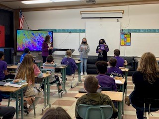 students in classroom for Purple Up day with Superintendent Arntzen 